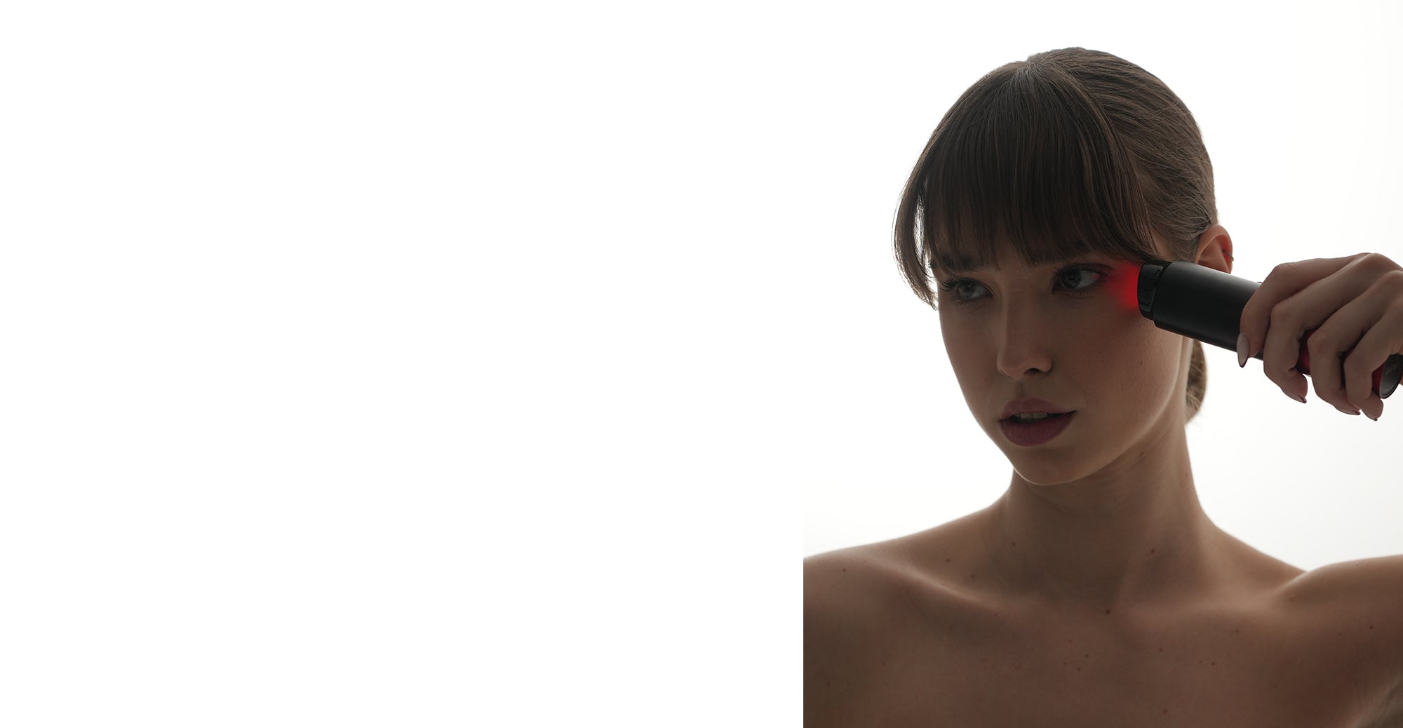 Woman demonstrating Dermao Radiance Microcurrent Device