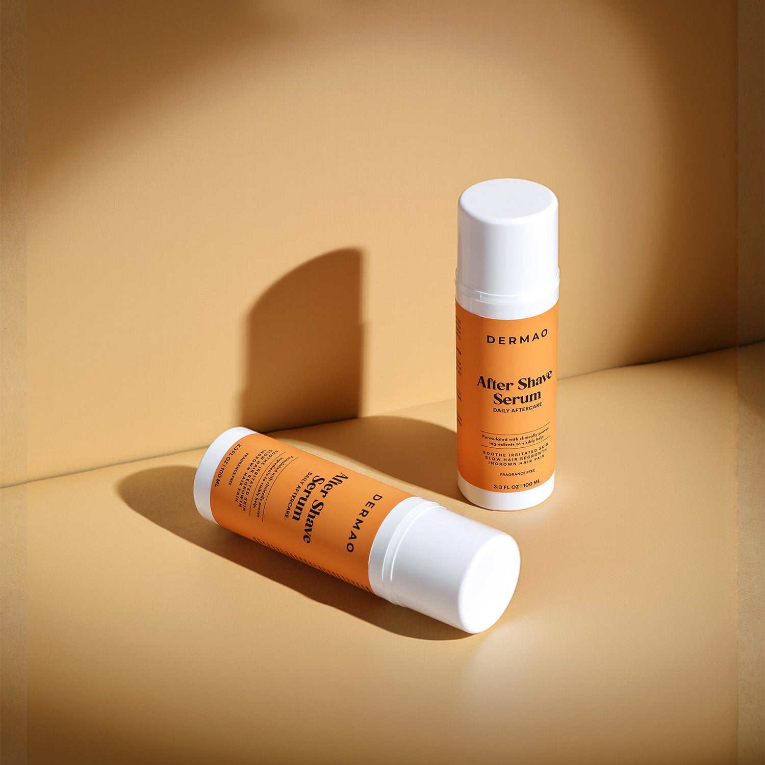 Two bottles of Dermao After Shave Serum on a beige background