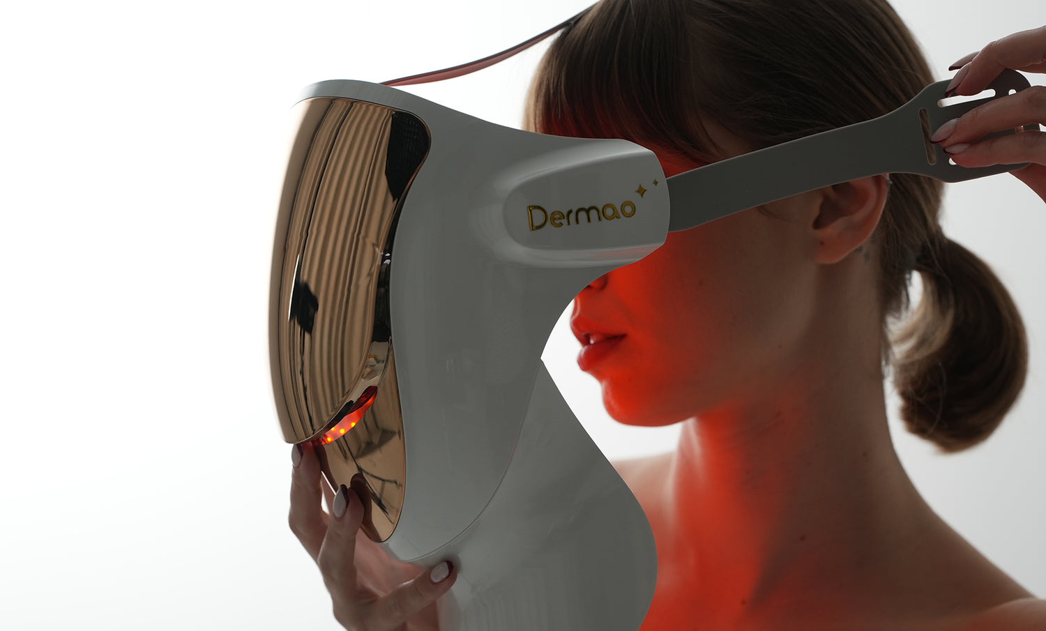 Woman putting on Dermao LED Mask