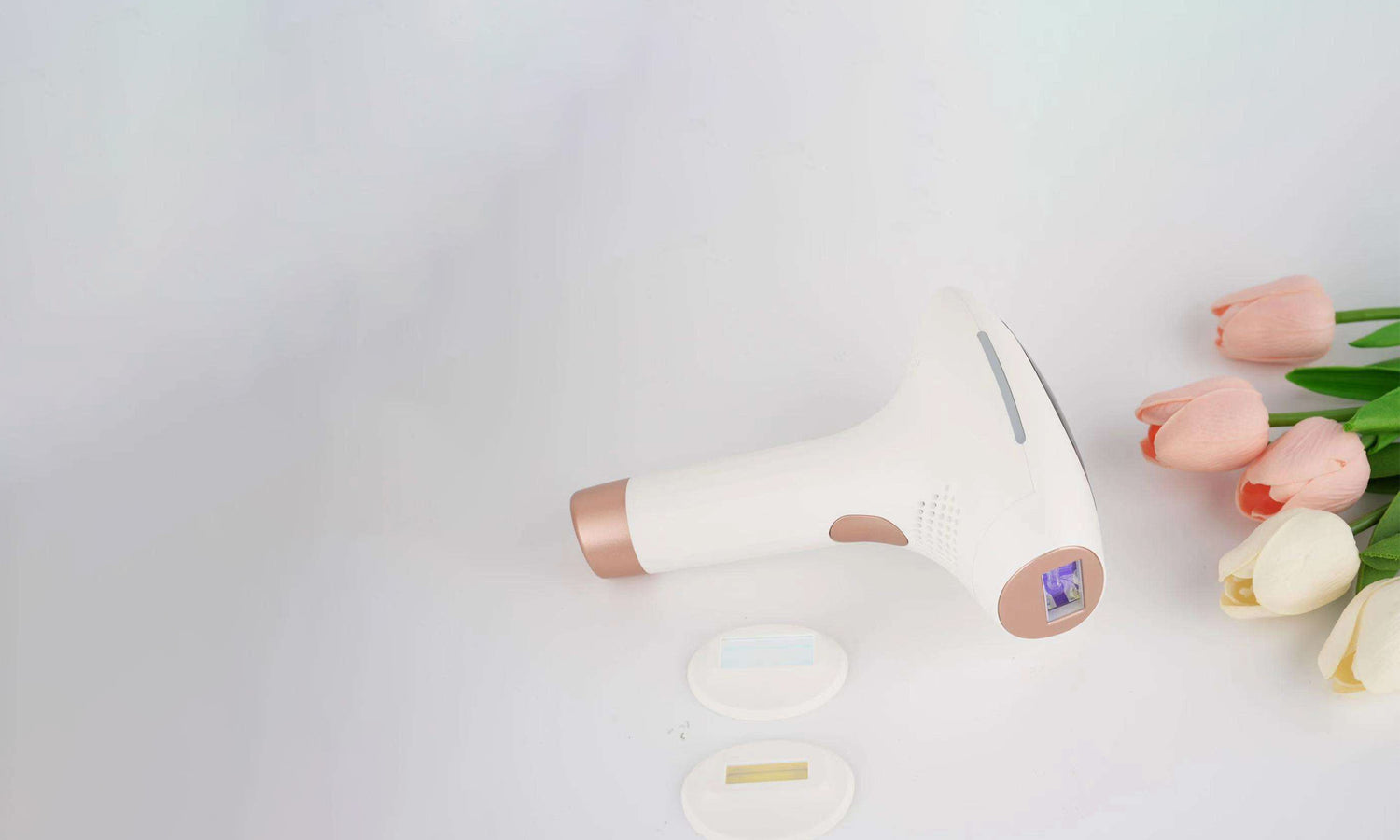 IPL Ice Cool with rose gold accents on a light gray background with pink flowers.