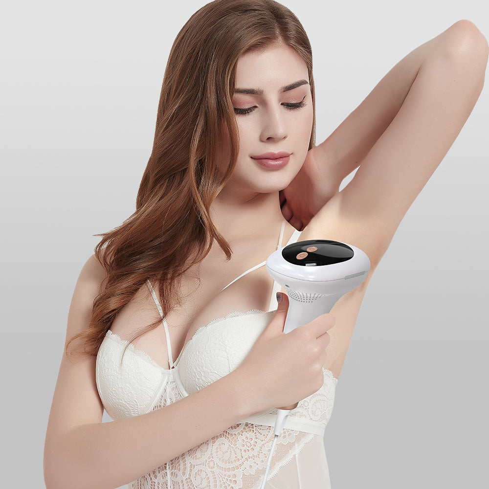 Woman using IPL Ice Cool on her arm against a plain background